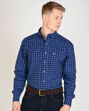 Model Wearing Generations Long Sleeved Plaid Shirt in Navy with Noble Outfitters Logo on Pocket 